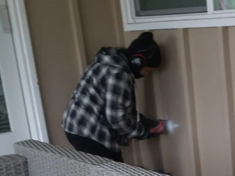 Professional electrician installing an exterior outlet in Sterling